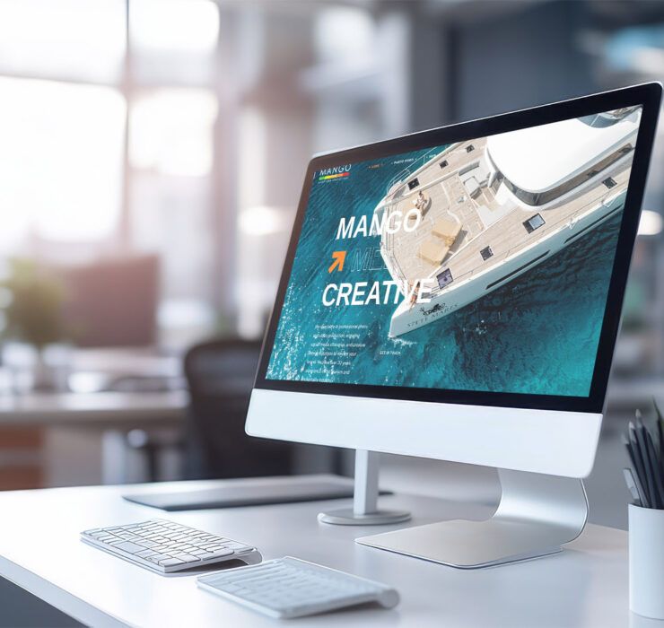 Modern computer display on an office desk with a web design stud